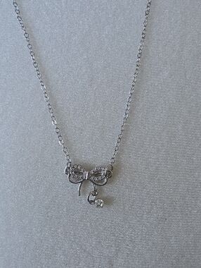 Delicate Silver Toned Bow Pendant Necklace with Crystal Accent